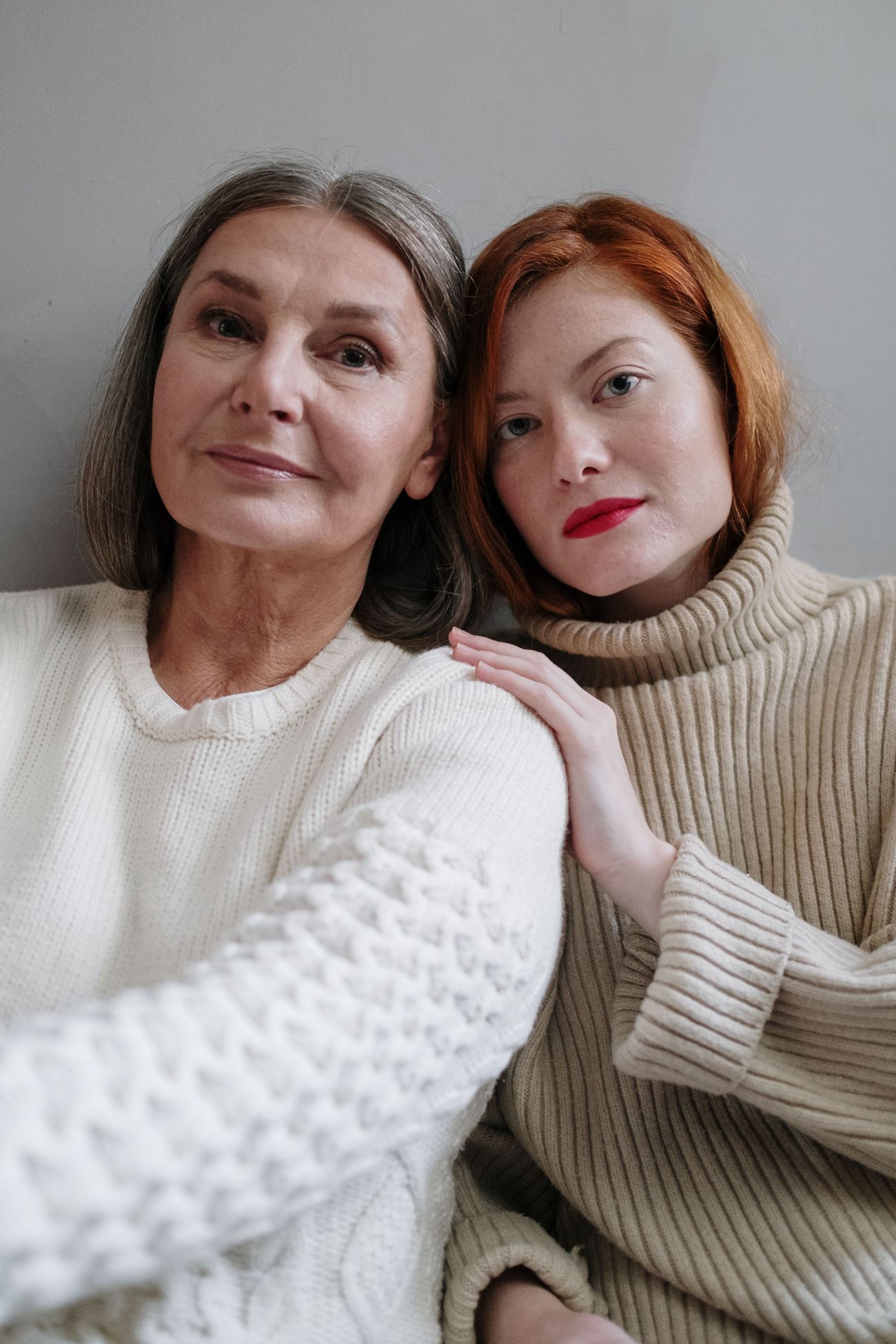 A mother and daughter leaning in close